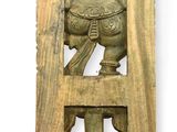 carved wooden plaque of a man holding a pot and a bird