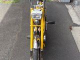 a yellow motorcycle parked on the side of the road