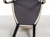 the back of a black and white chair with a wooden frame