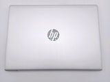 a white laptop with a hp logo on the screen