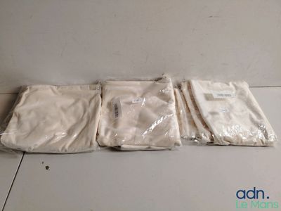trois sacs en tissu blanc posés sur une table blanche