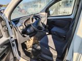 the interior of a car with the door open and the driver ' s seat down