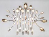 a lot of silver spoons and forks arranged in a circle