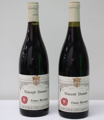 two bottles of wine sitting next to each other on a table