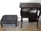 a small table and a small stool in a room