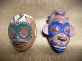 two masks that are sitting on a table