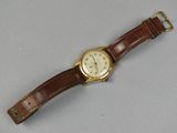 an image of a wrist watch with a brown leather strap