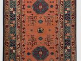 an orange and blue rug with a medallion design on it