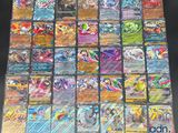 the collection of pokemon cards are displayed on a table