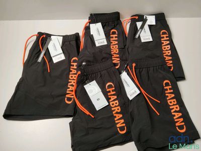 three pairs of black and orange pants with the words charban on them