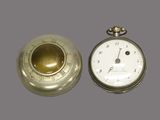 a silver pocket watch and a gold pocket watch on a gray background