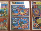 many pictures on the wall of a building with arabic writing on them