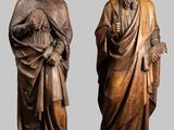 two statues of a man and a woman standing next to each other