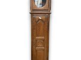 an old wooden grandfather clock with a mirror on the top of it