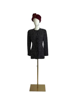 black and white tweed jacket and hat on a mannequin stand