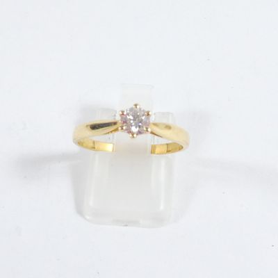 une photo d'une bague en or sertie d'un diamant