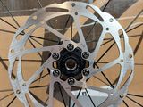 a bike wheel with a disc on the front of it