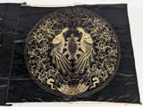 an image of a black and gold cloth with two birds on it