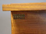 a close up of a wooden table with a name on it