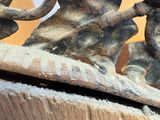 a close up of a piece of wood with a metal object on it
