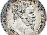 une pièce en argent avec l'image d'un homme de profil