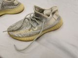 adidas yeez sneakers are on a bed with a white sheet