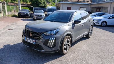 the grey suv is parked in a parking lot with other cars
