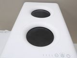 a white speaker that is sitting on top of a table