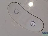 a close up of a remote control on a white surface