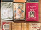 several old books are sitting on a wooden table next to each other