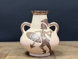 a vase with a picture of a man riding a horse on it