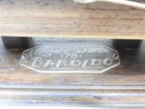 a glass plate with a name on it on a wooden table