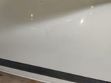 a close up of a white car with a black stripe