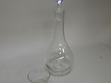 a glass and a decanter sitting on a table