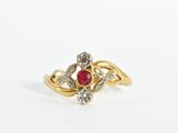 an image of a gold ring with a ruby stone and diamonds