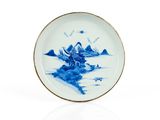 assiette en porcelaine bleue et blanche ornée d'un paysage
