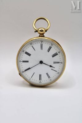 a gold pocket watch with roman numerals on the face