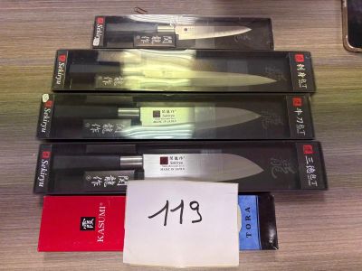 three knives sitting on top of each other on a table