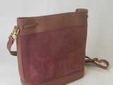 a brown and pink sued cross body bag on a white background