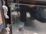 a man that is kneeling down in front of a microwave