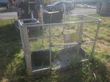 a metal cage with a water pump on it in the grass