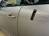 a silver car with a sticker on the side of it