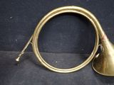 an old brass trumpet sitting on top of a black cloth