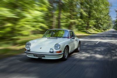 a white car that is driving down the road