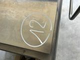 a close up of a metal table with a number on it