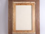 an old picture frame hanging on a wall with a white background