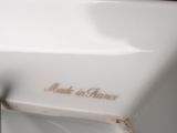 a close up of a white sink with a metal faucet