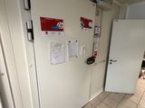 a white refrigerator and a white refrigerator freezer in a room