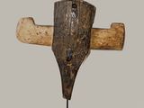 an image of a wooden sculpture of a cross on a stand