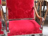 two red chairs sitting next to each other in a room
